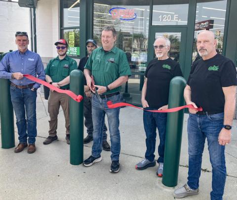 O’Reilly’s Auto Parts Manager Jerry Landenberger makes the opening of the new store at 120 E. Cedar Ave. official by cutting the ribbon with a group of O’Reilly’s employees Sunday morning.
