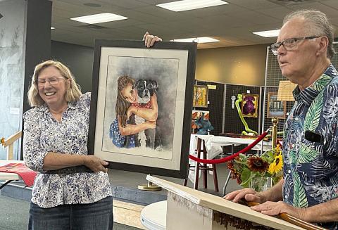 Jan Berg-Rezmer showing a 2025 winning entry to then Juror and founding member of Gladwin Artists, Lynn Morgan. CONNIE MAEDEL DIEHL