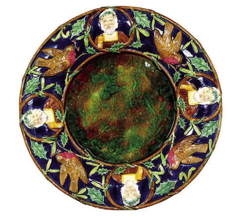 Victorian English majolica maker George Jones decorated this platter with English Christmas symbols that may be unfamiliar to Americans, but still have the spirit of the holiday. STRAWSER AUCTION GROUP