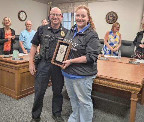 Gladwin Mayor Sarah Kile presents a plaque of appreciation to retiring Chief of Police Eric Killian Monday at an eventful Regular Meeting of the City Council.