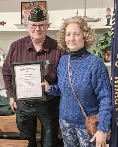 American Legion Post 171 Adjutant Rick Bratton presents Cynthia Krycian with a certificate declaring her an honorary member of the organization.
