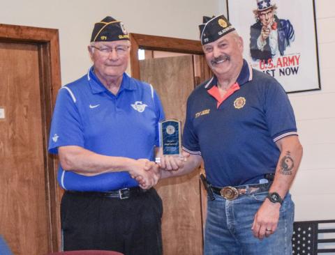 Terry Brokoff is pictured accepting an award from Jim Volant.