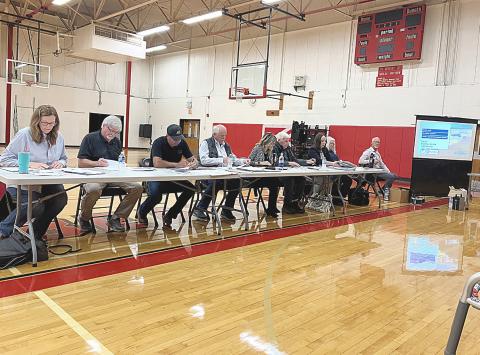 The members of the Ross Lake Improvement Board contemplate a weed remediation plan that they eventually rejected at a meeting last Wednesday night.