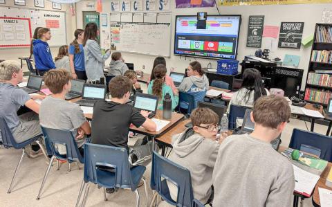 Students and co-workers get a FaceTime update from Gladwin Junior High School eighth grade English teacher Kim Kaleto (inset) live from the Boston Marathon last week.