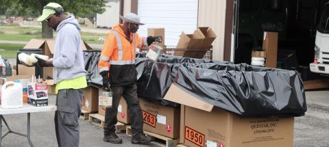 Workers sort out containers and dispose of them appropriately Saturday during Gladwin County Hazardous Waste Day at the Department of Public Works.
