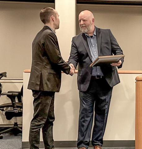 State Rep. Bill G. Schuette (far left) presents a tribute to Officer Steven Pomransky of the Midland Police Department at a Midland City Council meeting on Monday, Dec. 18.