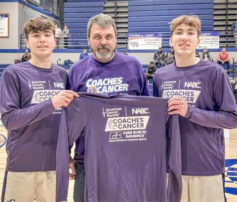 Farm Bureau Insurance Agent Duane Simpkins donated the commemorative jerseys worn by Gladwin’s basketball teams during the Coaches Vs. Cancer games last week and he was thanked pregame by Brody and Ben Verellen.
