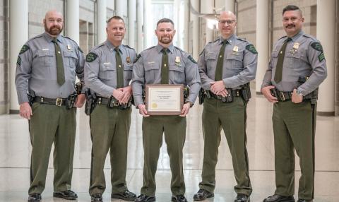 Michigan DNR Conservation Officer Kyle McQueer is pictured with leadership from the DNR Law Enforcement Division, including (left to right) Acting 1st Lt. Stephen Mooney, Chief Brandon Kieft, McQueer, Acting Asst. Chief Gerald Thayer and Sgt. Chris Holmes.