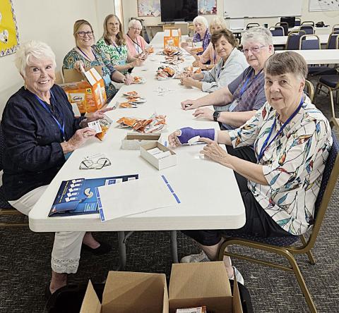MARSP chapter members gather for a work-bee to prepare snack bags for distribution to all Gladwin and Beaverton Public School staff at one of their staff gatherings before school begins.