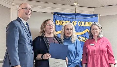 Prior to addressing the recent Gladwin County Chamber of Commerce Legislative Breakfast, Congressman John Moolenaar presented a Certificate of Special Congressional Recognition to Gladwin City-County Transit in honor of its 50th year of community service. At the podium are (left to right) Moolenaar, Transportation Director Kim Bruner, Executive Director Lori Stout and Chamber Director Carrie Will.