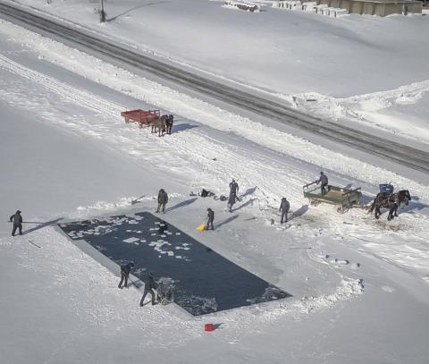 An aerial view of Amish cutting and collecting squares of ice and putting them on to horse drawn carts. PHOTOS PROVIDED BY ROGER HAINES