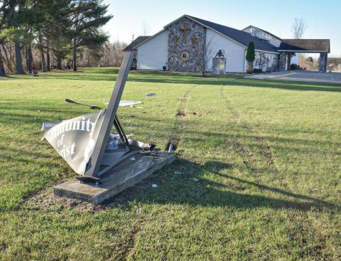 Tire tracks and the wiped out Community of Christ Church sign show the path of a vehicle that was involved in a crash with Sheriff Mike Shea last week.