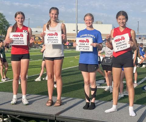 Gladwin Junior High’s Aria Rule (third from left) takes to the podium after placing second at the regional in the high jump last week.