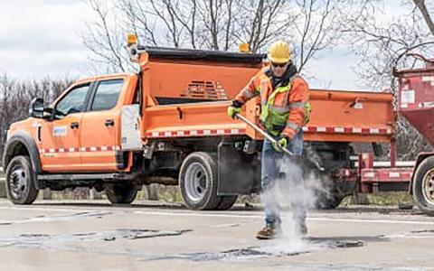 Department of Transportation crew fill a pothole on a state highway. MICHIGAN DEPARTMENT OF TRANSPORTATION