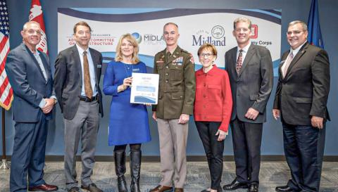Gathered after the signing of the agreement for the General Investigation study with the Corps of Engineers are pictured, left to right: Mark Bone, chair, Midland County Board of Commissioners; J.W. Fisher and Lee Ann Keller, co-chairs of the Midland Business Alliance (MBA) Advisory Committee on Infrastructure; Lt. Col. Wallace Bandeff, commander, U.S. Army Corps of Engineers Detroit District; Maureen Donker, mayor, City of Midland; Brad Kaye, Midland city manager; and Tony Stamas, president and CEO, MBA.