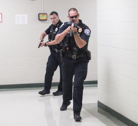 Police officers practice dealing with an active assailant situation during a training session at Gladwin Junior High School Thursday that involved multiple local agencies.