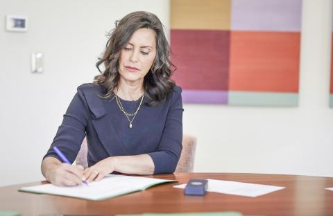 Governor Whitmer is pictured signing six commonsense bills into law.