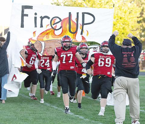 The Beaverton football team breaks the paper and takes the field with fire prior to a big 54-8 victory over Pinconning Friday night that put a triumphant stamp on an eventful Homecoming weekend for the community. See the story on B- 1! PHOTO BY JESSICA KELLER