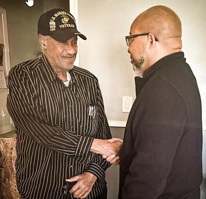 Lawrence Brooks (left) shakes hands with MVAA Director Brian L. Love.