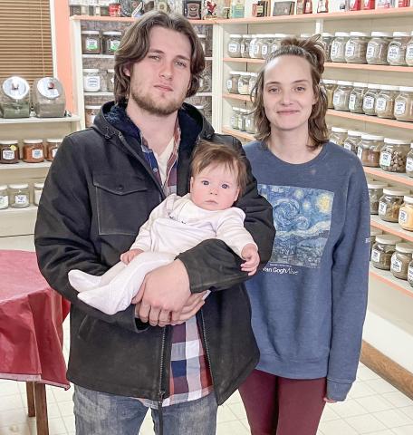 Gabriel Hadley is pictured with baby Meredith, and wife, Lilly.