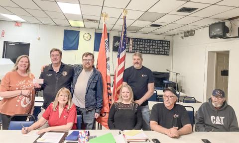 Gladwin County Office of Veterans Affairs Director Ken Roberts (back row, second from left) accepts a donation from the officers of the Gladwin Eagles 3292 Riders at a meeting of the club Friday night