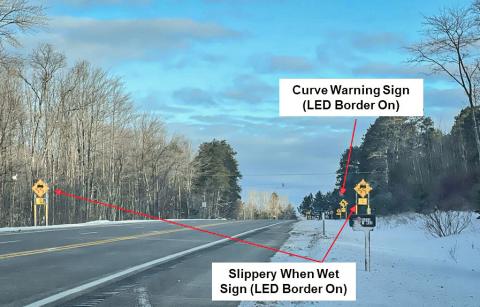 Example of activated slippery curve warning system signs on westbound M-32 near Gaylord. MICHIGAN STATE UNIVERSITY