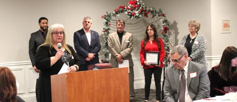 Executive Director Yvette Keast accepts the Inspiring Community Partner of the Year Award at the Alumni Celebration on December 8 at Riverwalk Place.