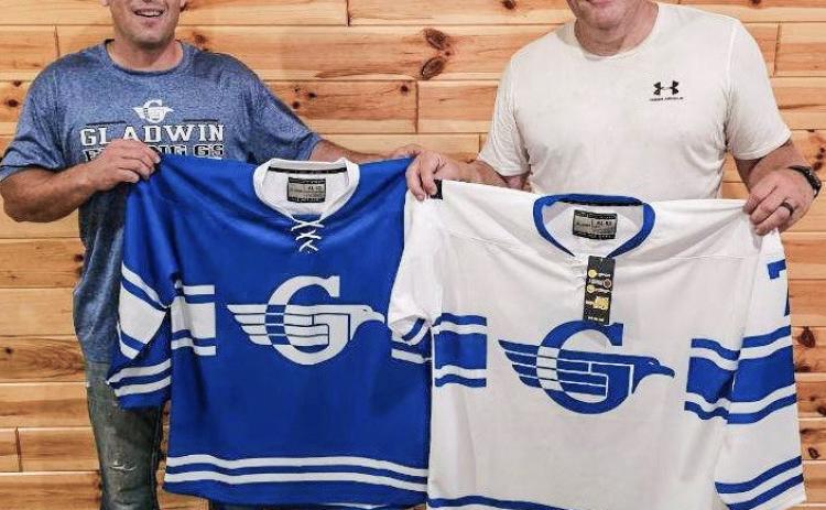 Pictured are Bill von Matt and Joseph Rowley with Gladwin Flying G hockey jerseys.
