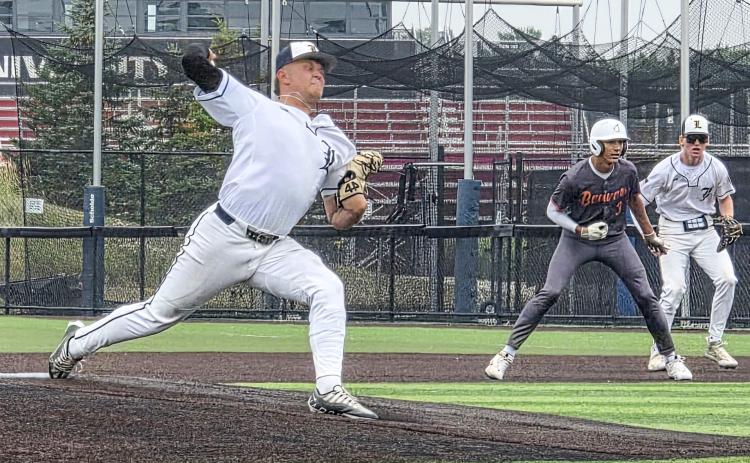 Mason Meier delivers a pitch versus the Beavers in the Panther Classic. Beaver player Garrison Zuker leads off first base as Bryce Neitzel looks on. GRAND RAPIDS