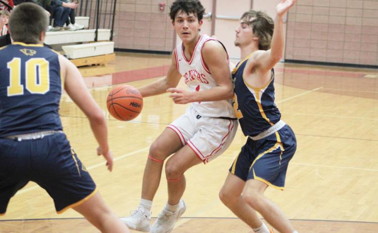 Beaverton’s Sean Barta tries to slip between two Standish defenders during Friday night’s loss to the Panthers. SCOTT SALOWICH