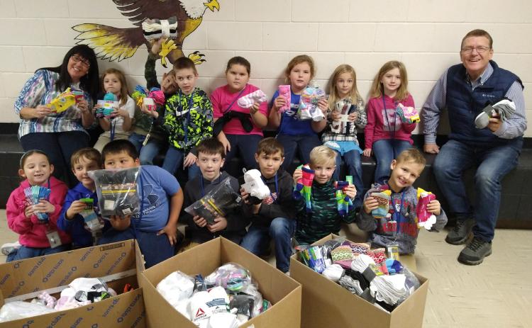 Skeels Christian School first and second grade students give Dave and Beulah Mead of Christmas Kindness 1,400 pairs of socks!