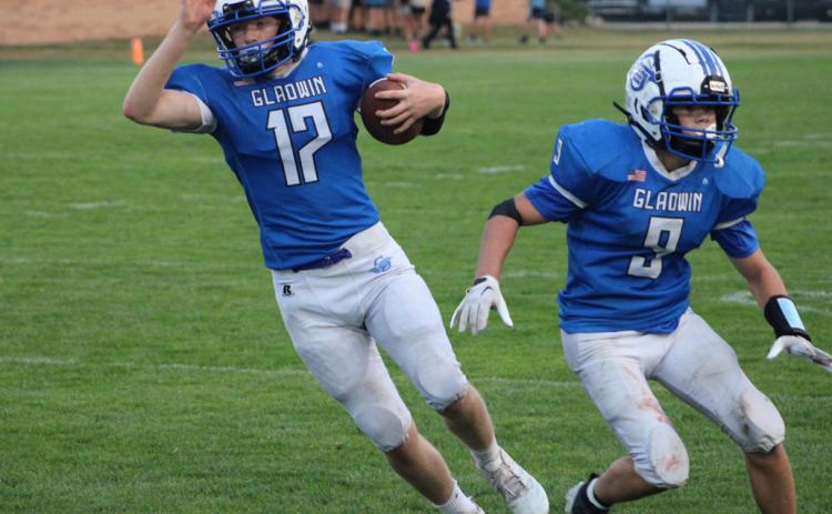 Caden McKeever cuts behind blocker Kolten Greaves during a recent Gladwin junior varsity football game.