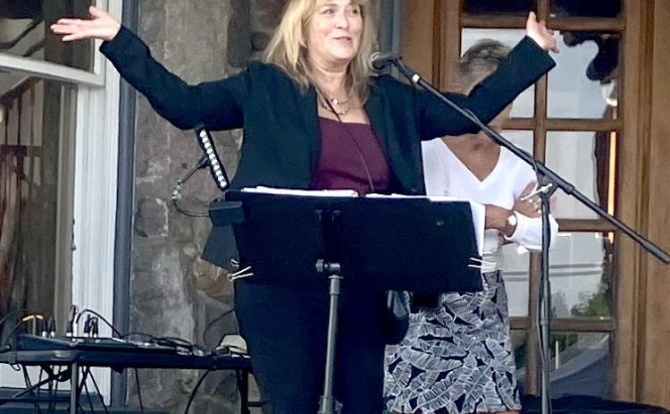 Char Stone House owner Sheryl Sacry welcomes the crowd and brings on the band Thursday at the new restaurant’s first event.