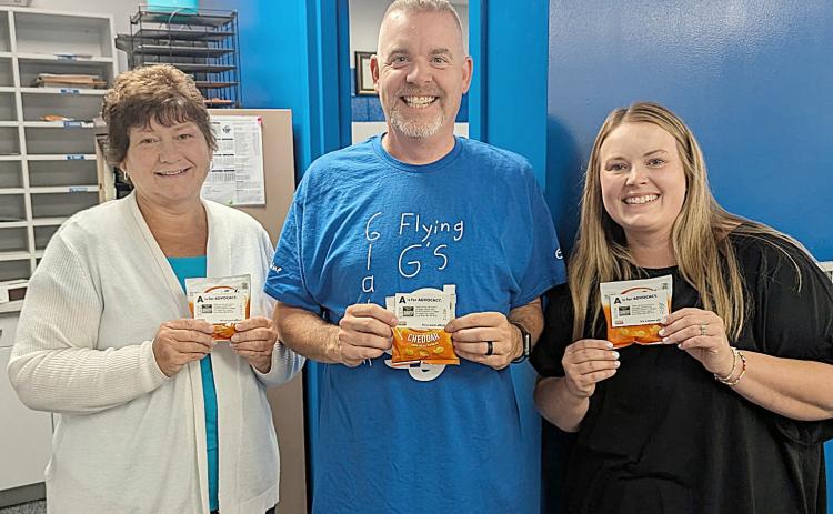 Holding their snack appreciation bags are Gladwin Intermediate School Secretary, Jen Slabic; GIS Principal, Bryan Randle; and GIS Librarian and Special Education Secretary, Ciara Robinette.
