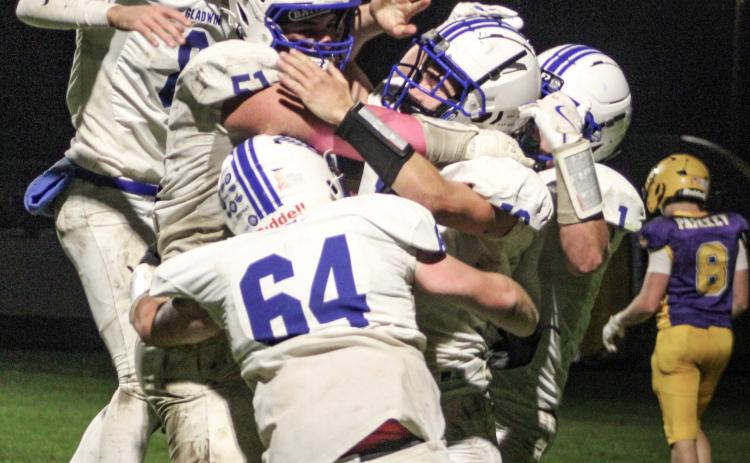 Jacob Pahl is mobbed by his teammates after catching a touchdown pass on the last play of the game Friday night to give Gladwin a 26-20 victory over Ogemaw Heights and the Jack Pine Conference Division 1 championship. OGEMAW