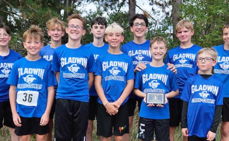 The Gladwin Junior High Boys Cross Country Team ran their way to a second place overall finish in Mt. Pleasant on Oct. 11. They are pictured here after their meet with their plaque. There were 137 runners and nine teams in the race.