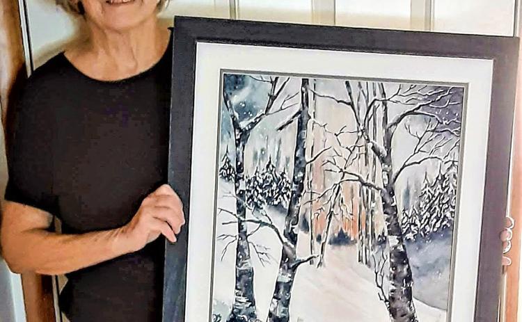 Longtime Gladwin Area Artist Guild member, Dorothy Koloff, at the 2021 Fall Show holding her painting, Magic of Winter, that won the Viewer’s Choice award that year.