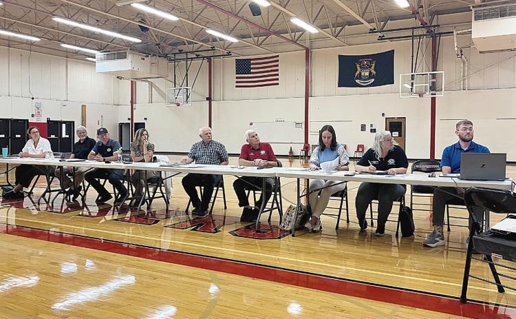 The Ross Lake Improvement Board presides over a meeting considering special assessments for weed remediation with residents and property owners Thursday at Beaverton Elementary School.