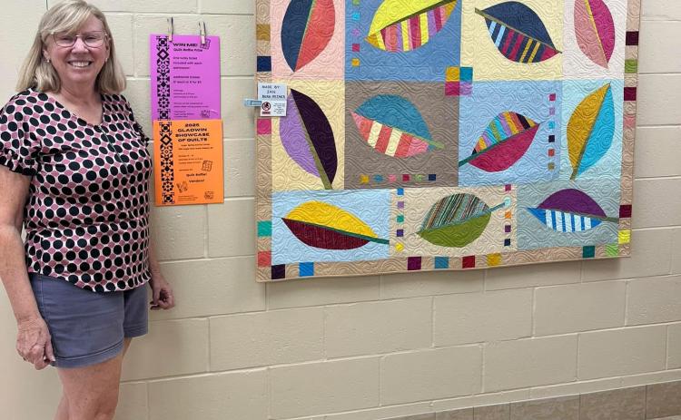 One of two beautiful quilts to be auctioned off during the show. Pictured is local artist Jan Berg-Rezmer, who made this quilt.