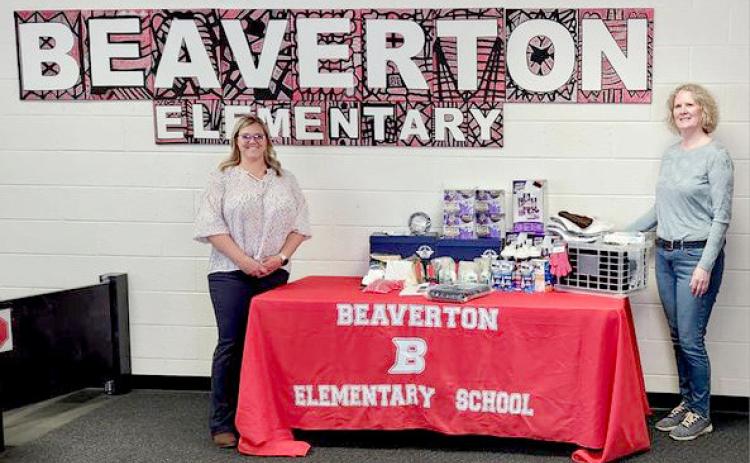 Beaverton Elementary School Principal, Renee Inscho, on left, accepts DAR donation from chair Nancy Pnacek.