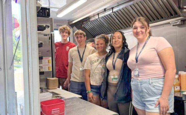 A group of campers from 2025 LAB Week, where students designed and pitched their own food truck concepts while learning how businesses differentiate themselves through branding, customer experience, pricing, and location strategy.