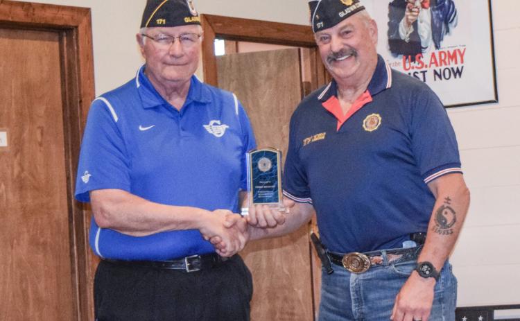 Terry Brokoff is pictured accepting an award from Jim Volant.