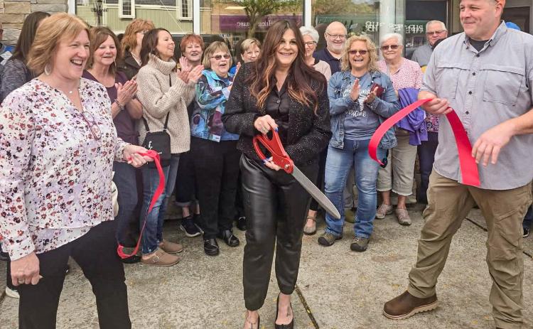 RIBBON’S CUT, NOW ABOUT THAT HAIRDO...
