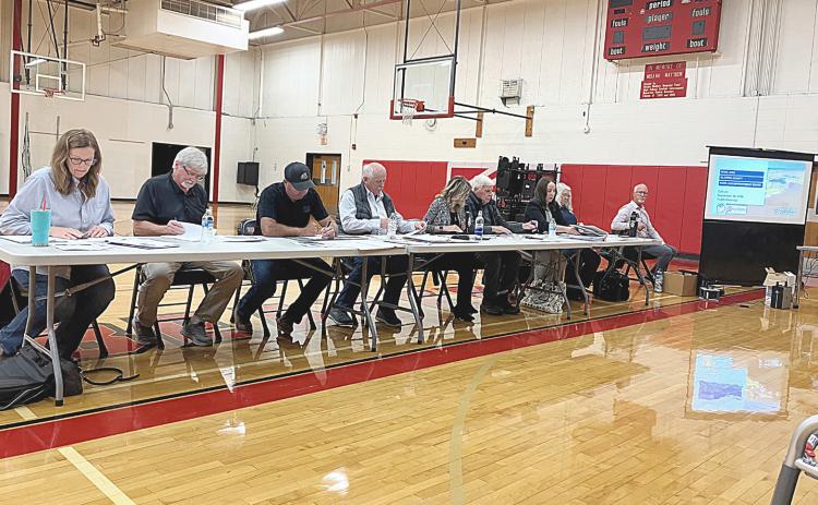 The members of the Ross Lake Improvement Board contemplate a weed remediation plan that they eventually rejected at a meeting last Wednesday night.