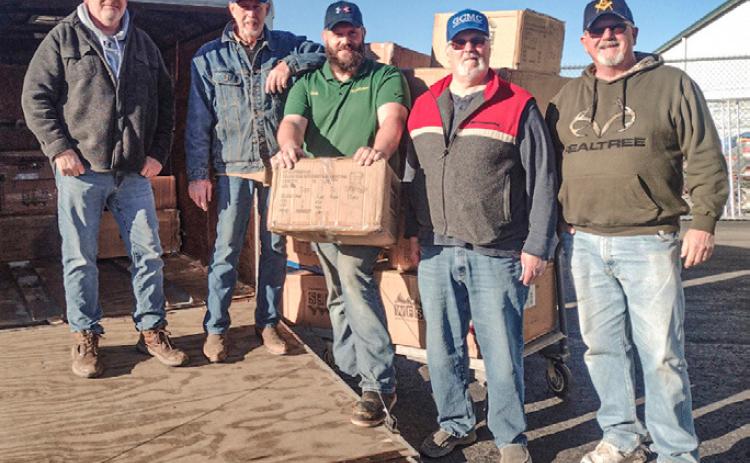 The Gladwin Christian Men’s Club Picking up 2024 boot order at Family Farm &amp; Home.