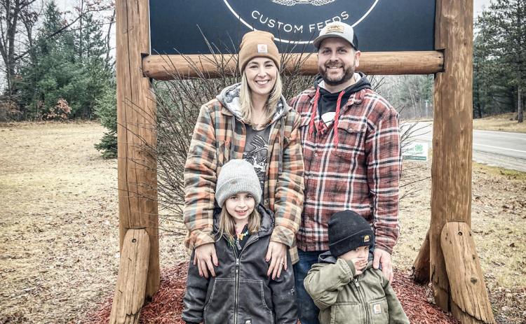 Alysia (left) and Troy (right) Govitz and their two children outside of their new business, The Feed Store located at 2461 S. M-30.