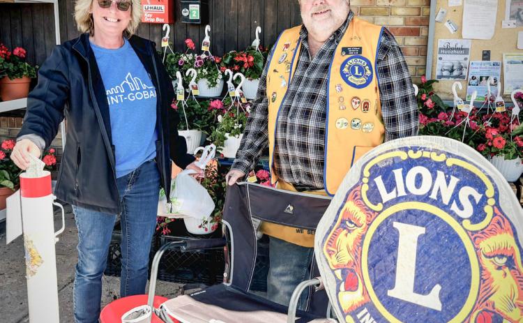 Pictured is Sandy Dollen, with Lions Club member, Mike Stroman, during the White Cane fund drive.