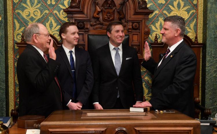 State Rep. Mike Hoadley (right), of Au Gres, is sworn in by former House Clerk Gary Randall (far left) on Wednesday, Jan. 11 at the state Capitol. Hoadley was joined by legislative staff members (from left) Ryan Zoschnick and Trevor Pittsley for the ceremony.