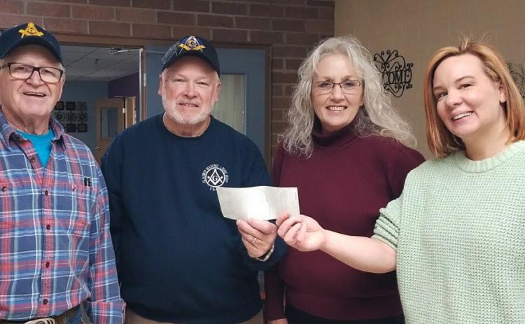 Representatives of the Masonic Lodge passing along their $200 donation to the Gladwin Council on Aging.
