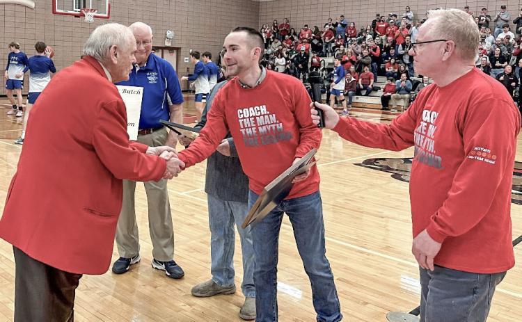 State Rep. Bill G. Schuette presents a tribute to Beaverton High School boys varsity basketball coach Roy Johnston on Friday, Feb. 23. Johnston is retiring at the conclusion of the season after coaching at Beaverton for a historic 50 seasons.